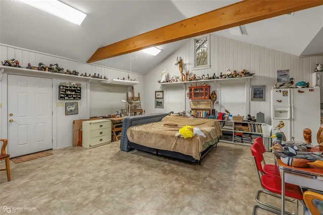 a bed room with a bed and a chair