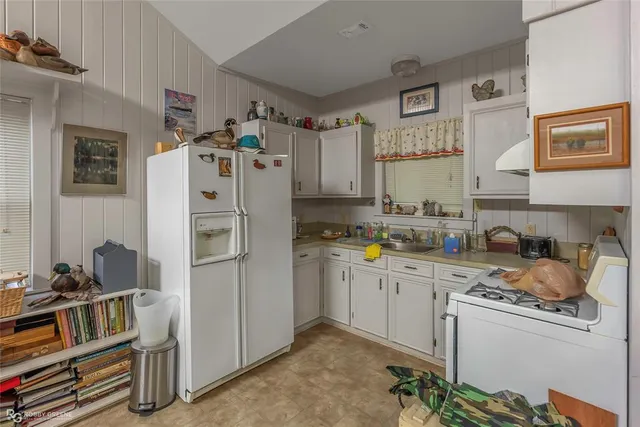 a kitchen with refrigerator and cabinets