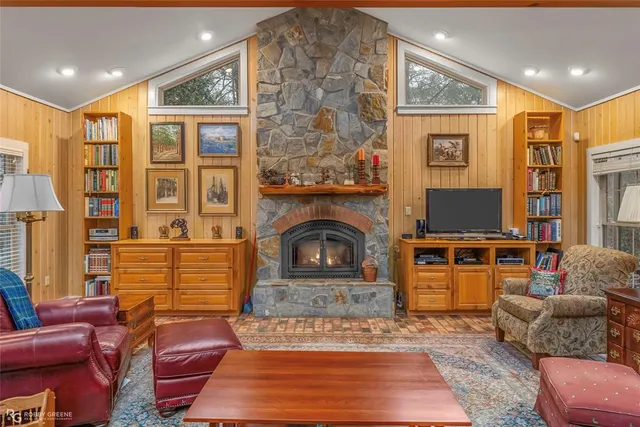 a living room with furniture a rug and a fireplace