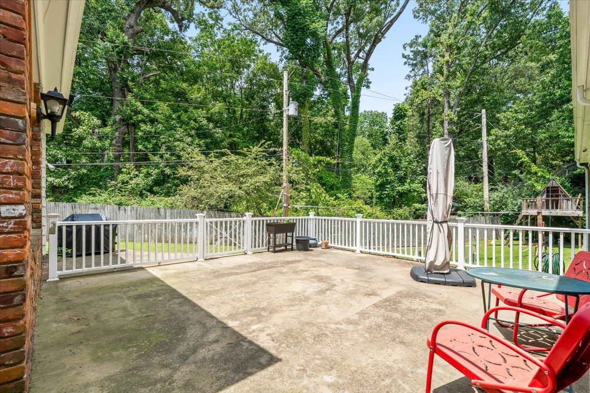 1273 Brookfield Road Memphis, TN 38119 - Photo 34 of 40 Concrete patio featuring a white vinyl railing and brick exterior accents