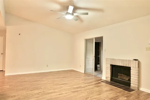 a view of an empty room with a fireplace