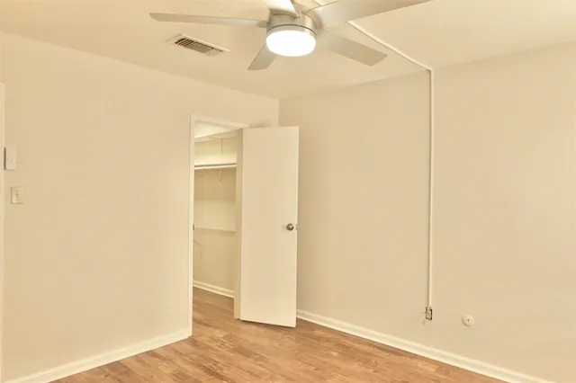 a view of a room with wooden floor