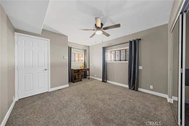 a view of a livingroom with a projector & cabinets