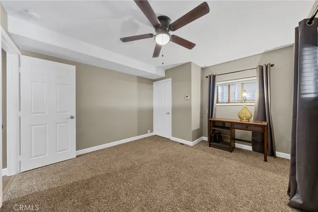 a view of workspace with window and ceiling fan