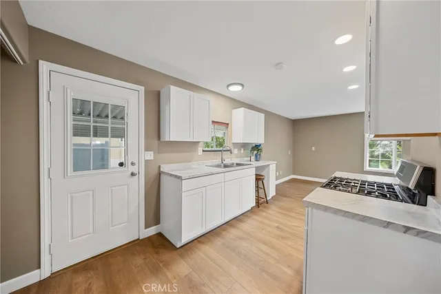 a kitchen with a sink stove and cabinets