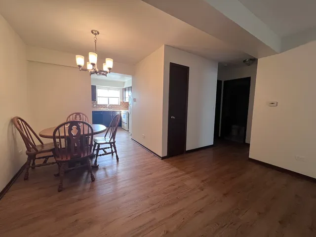 a view of a dining room with furniture wooden floor and chandelier