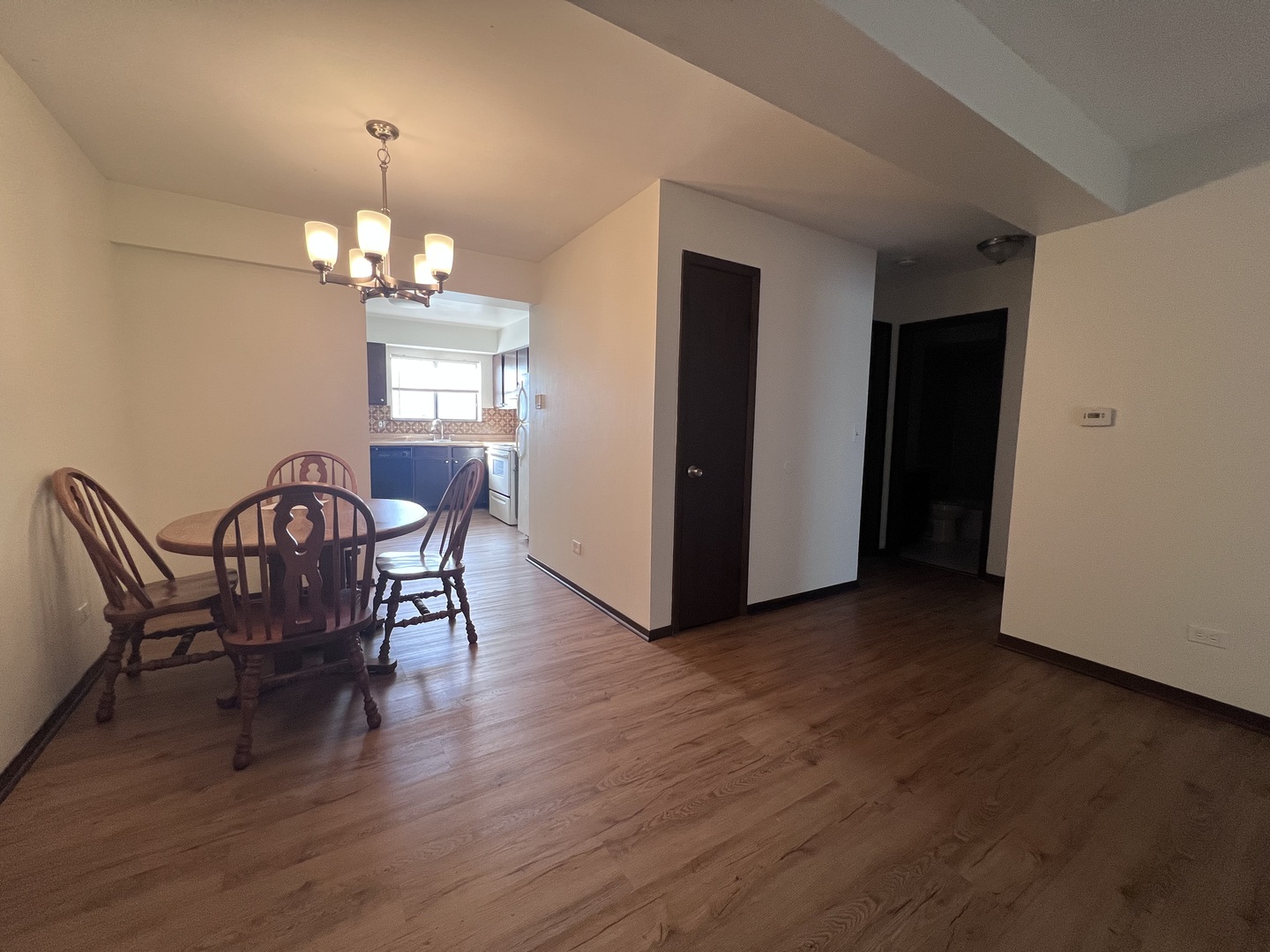 1779 Rand Road, Unit 1B Des Plaines, IL 60016 - Photo 3 of 8 a view of a dining room with furniture wooden floor and chandelier