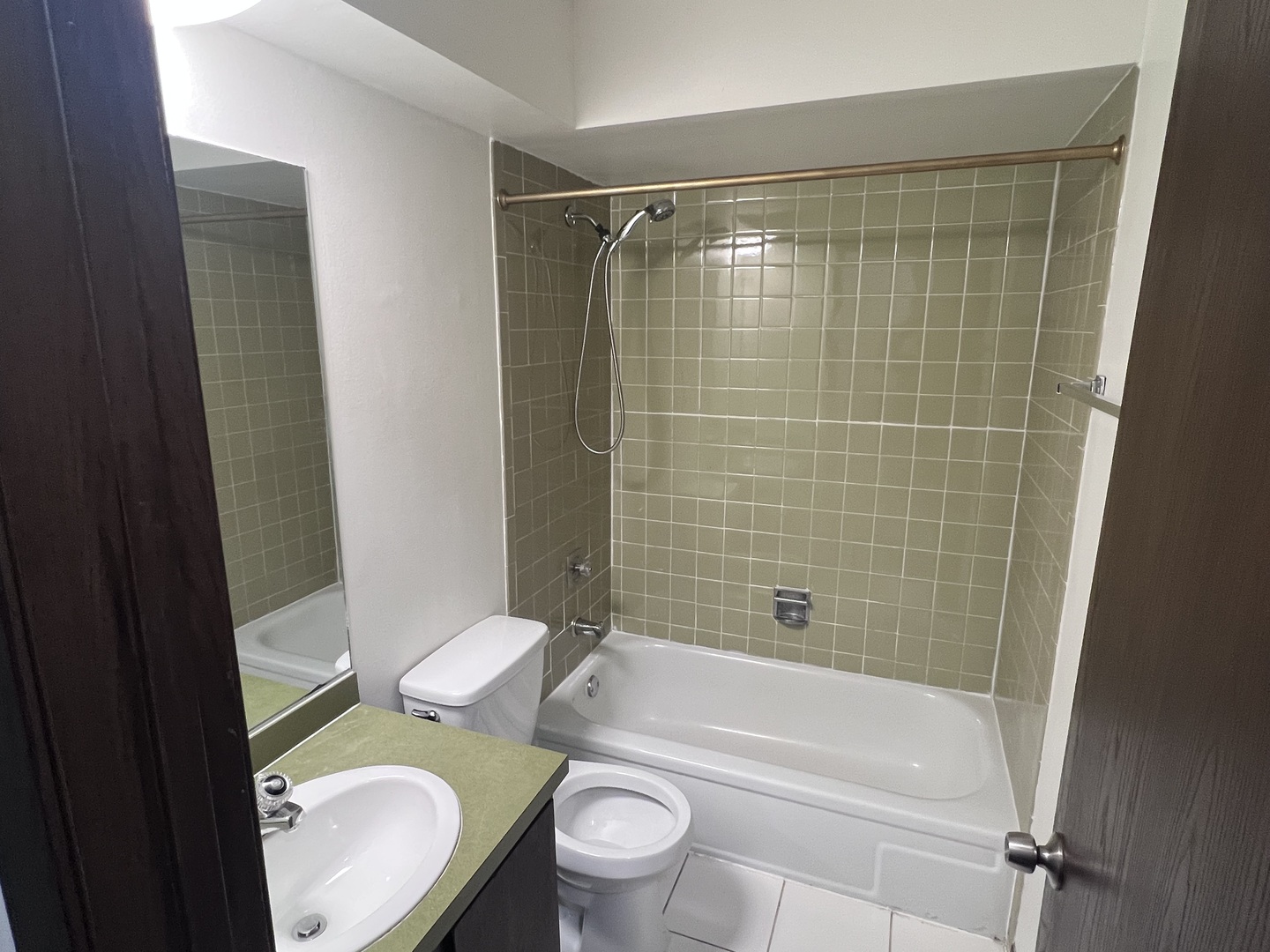 1779 Rand Road, Unit 1B Des Plaines, IL 60016 - Photo 7 of 8 a bathroom with a granite countertop toilet sink and shower