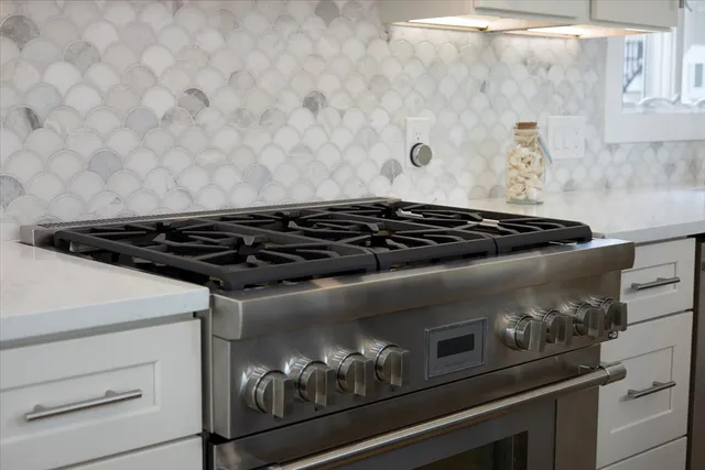 a close up of a stove top oven sitting inside of a kitchen