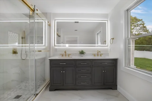 a bathroom with a granite countertop sink mirror and double