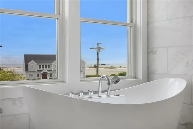 a view of a bathroom with a bathtub and a sink