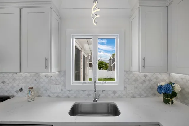 a bathroom with a sink and a window