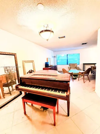a living room with furniture a rug and white walls
