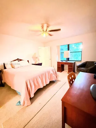 a bedroom with bed and window