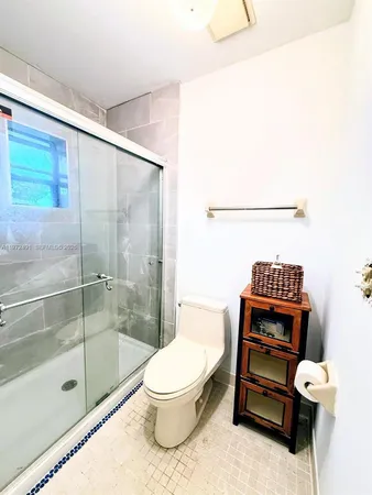 a bathroom with a toilet and a shower