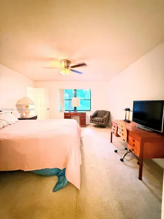 a bedroom with a bed and flat screen tv