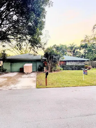 a view of a house with a yard and garage