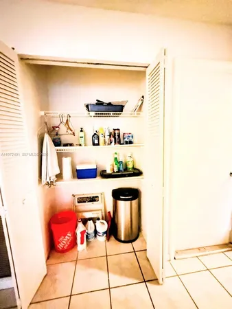 a kitchen with stainless steel appliances kitchen island granite countertop a refrigerator and a stove