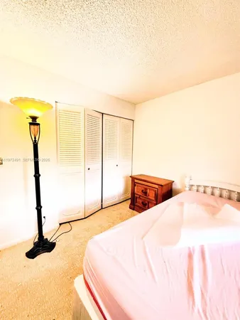 a bedroom with a bed and a night stand