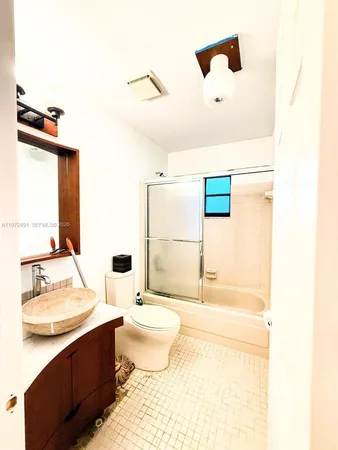 a spacious bathroom with a bathtub sink and mirror
