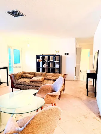 a living room with a table and chairs