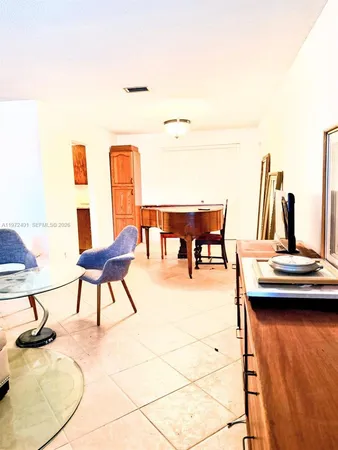 a balcony with table and chairs