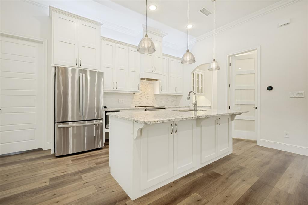 444 Ben Boyd Road Argyle, TX 76226 - Photo 12 of 28 a kitchen with stainless steel appliances granite countertop a refrigerator a sink dishwasher a oven and a wooden floor