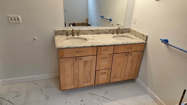 a bathroom with a sink toilet and mirror