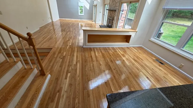 a view of empty room with wooden floor