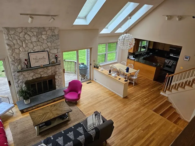 a view of a living room with furniture and flat screen tv