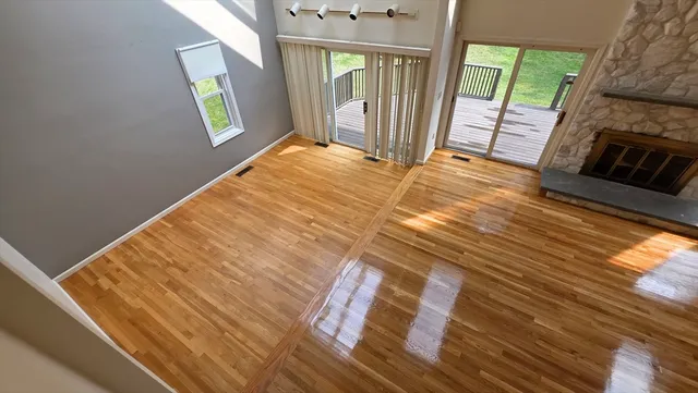 a view of a living room with furniture and a fireplace