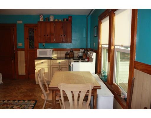 114 Belchertown Street Three Rivers, MA 01080 - Photo 4 of 27 a kitchen with a table chairs and cabinets