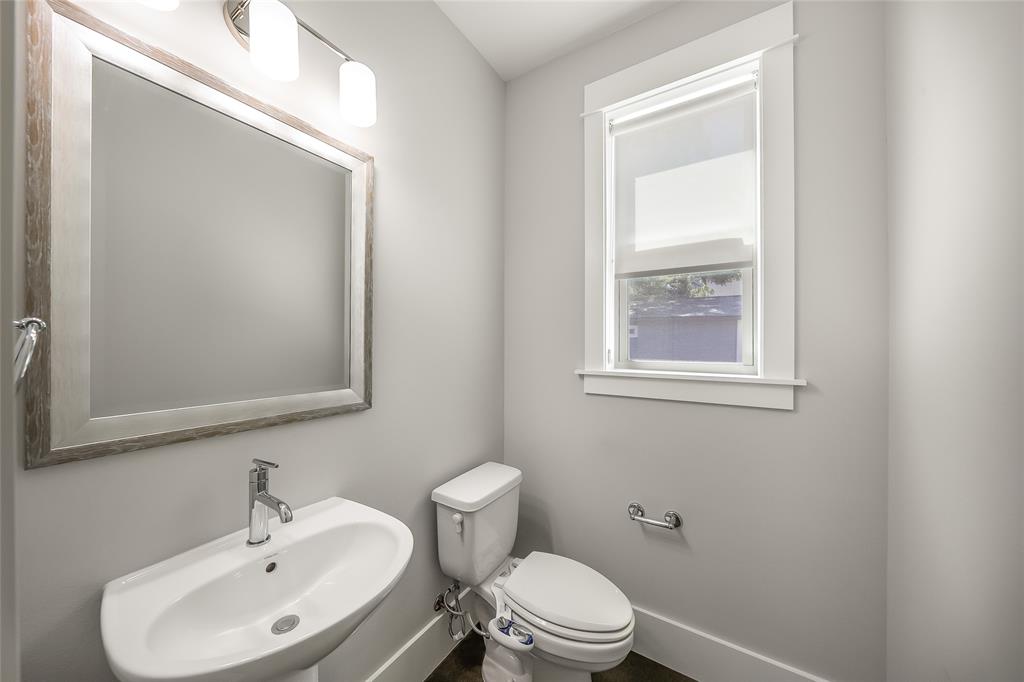 2821 Castro Street, Unit 1 Austin, TX 78702 - Photo 11 of 21 Pedestal sink with chrome faucet, framed mirror, and contemporary vanity lighting