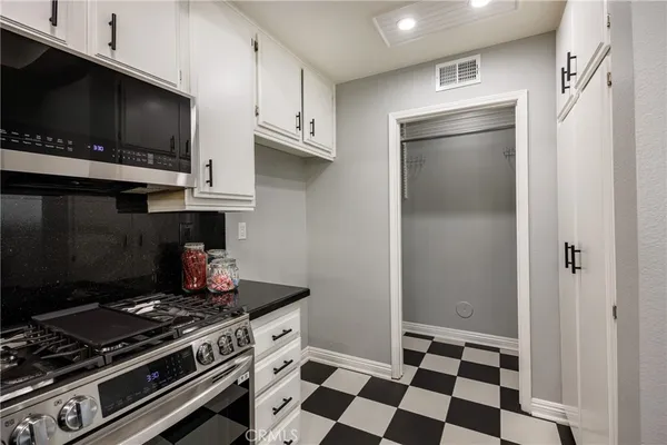 a kitchen with stainless steel appliances and cabinets