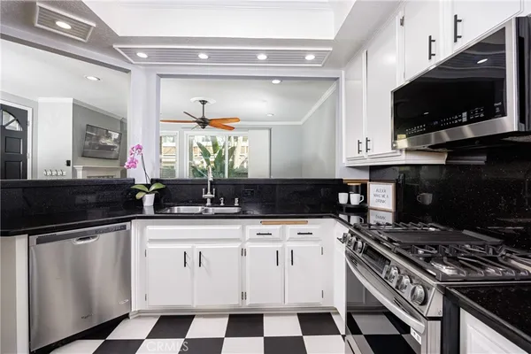 a kitchen with a sink stove and microwave