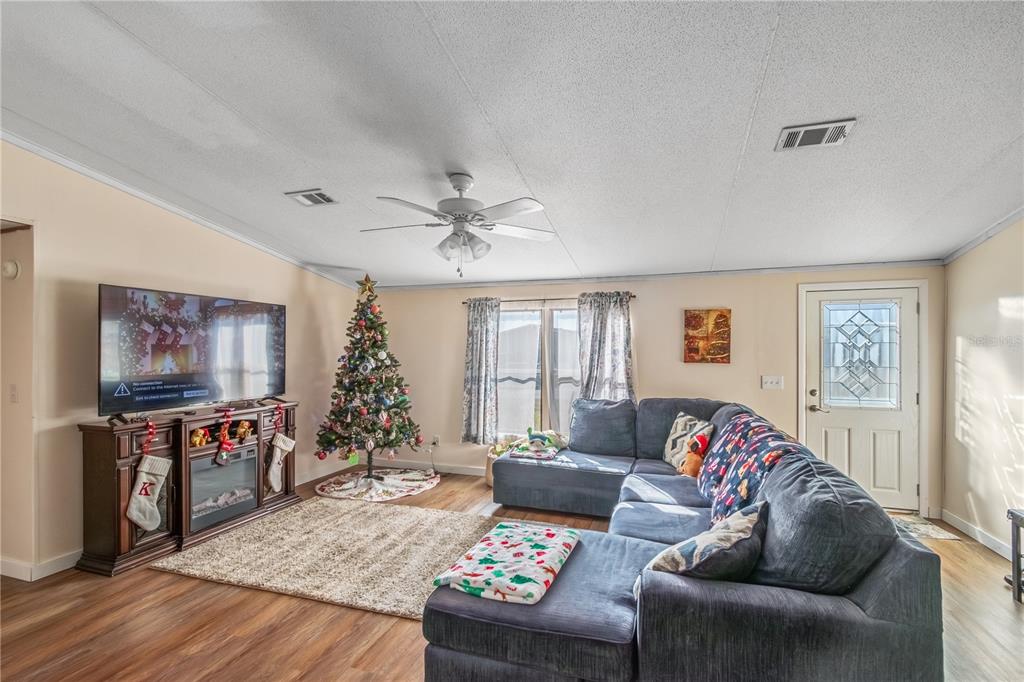 6601 Southwest 84th Street Ocala, FL 34476 - Photo 19 of 36 a living room with furniture and a flat screen tv