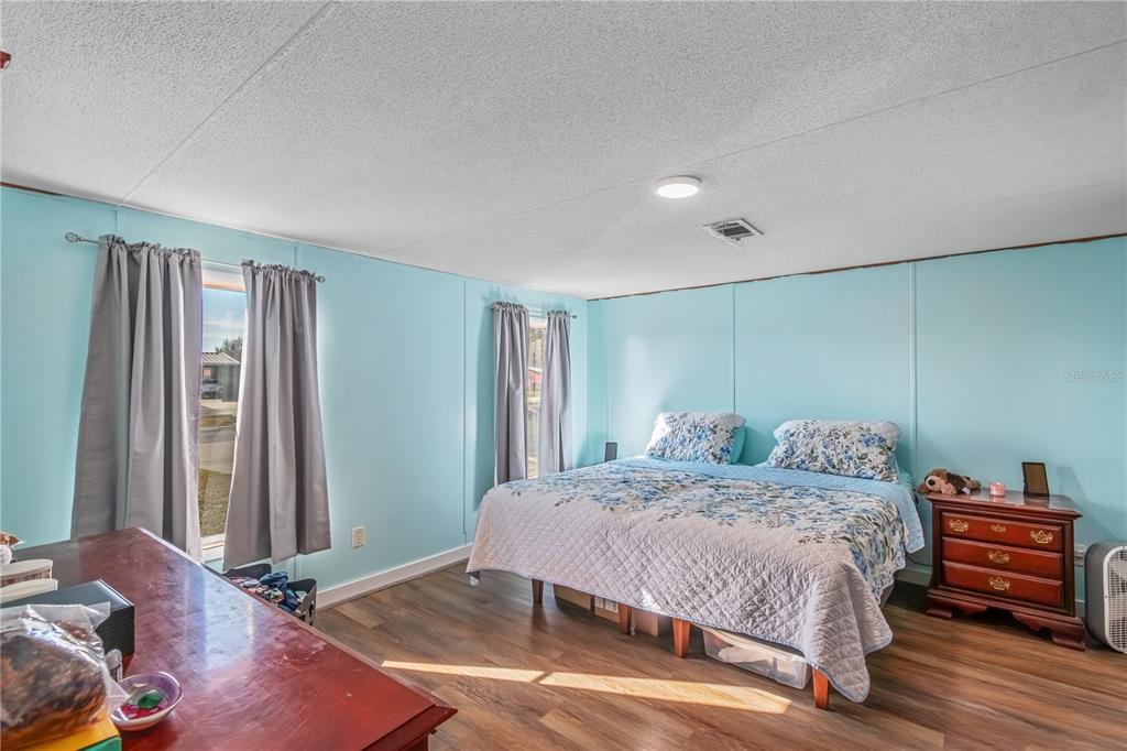 6601 Southwest 84th Street Ocala, FL 34476 - Photo 23 of 36 a bedroom with a bed and wooden floor