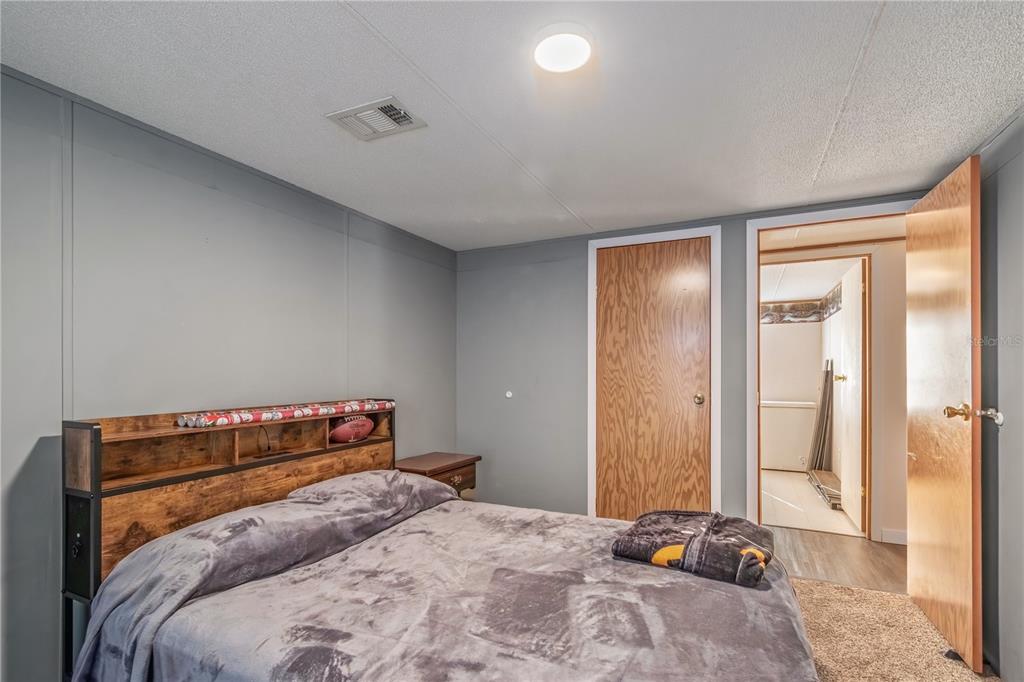 6601 Southwest 84th Street Ocala, FL 34476 - Photo 32 of 36 a bedroom with a bed and a cabinets