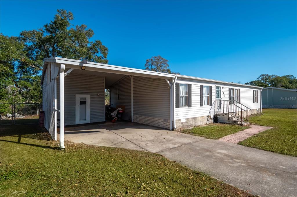6601 Southwest 84th Street Ocala, FL 34476 - Photo 4 of 36 a front view of a house with garden