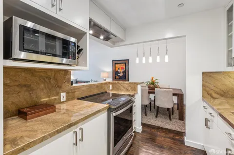 a kitchen with stainless steel appliances granite countertop a stove and a microwave