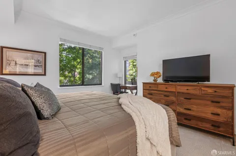 a bedroom with a bed and a flat screen tv