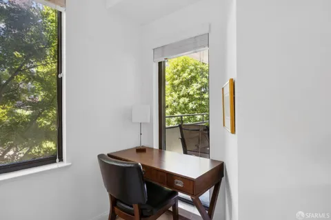 a view of a dining room with a table and chairs