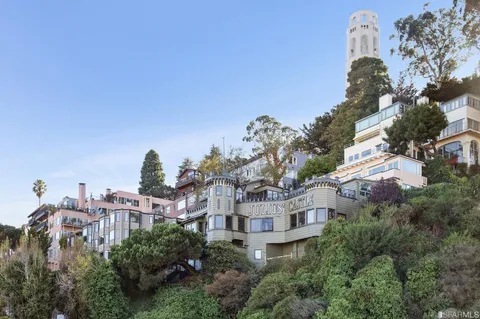 an aerial view of multiple houses with yard