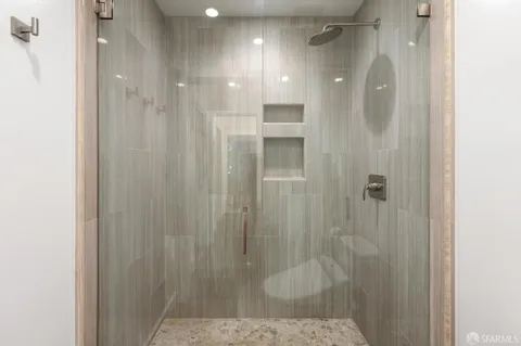 a bathroom with a shower and a sink
