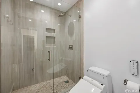 a bathroom with a shower and toilet