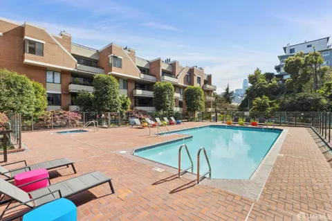 a swimming pool with outdoor seating and yard