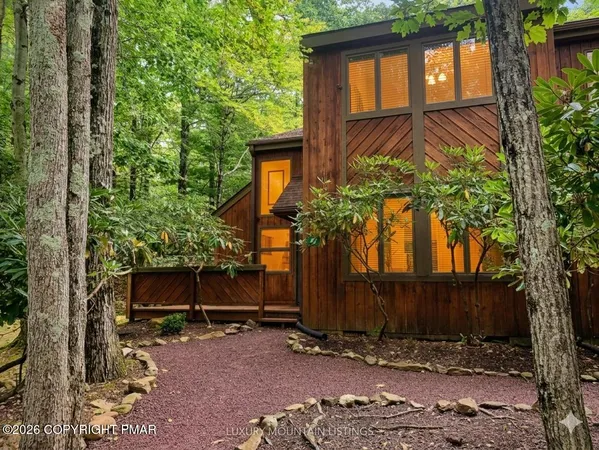 a view of a house with a tree in the yard