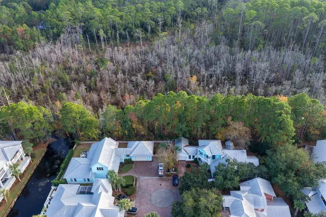 an aerial view of a house with a yard and trees