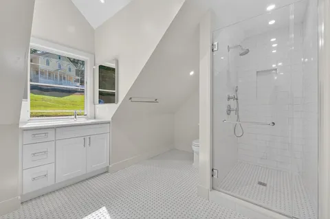 a bathroom with a shower and a sink