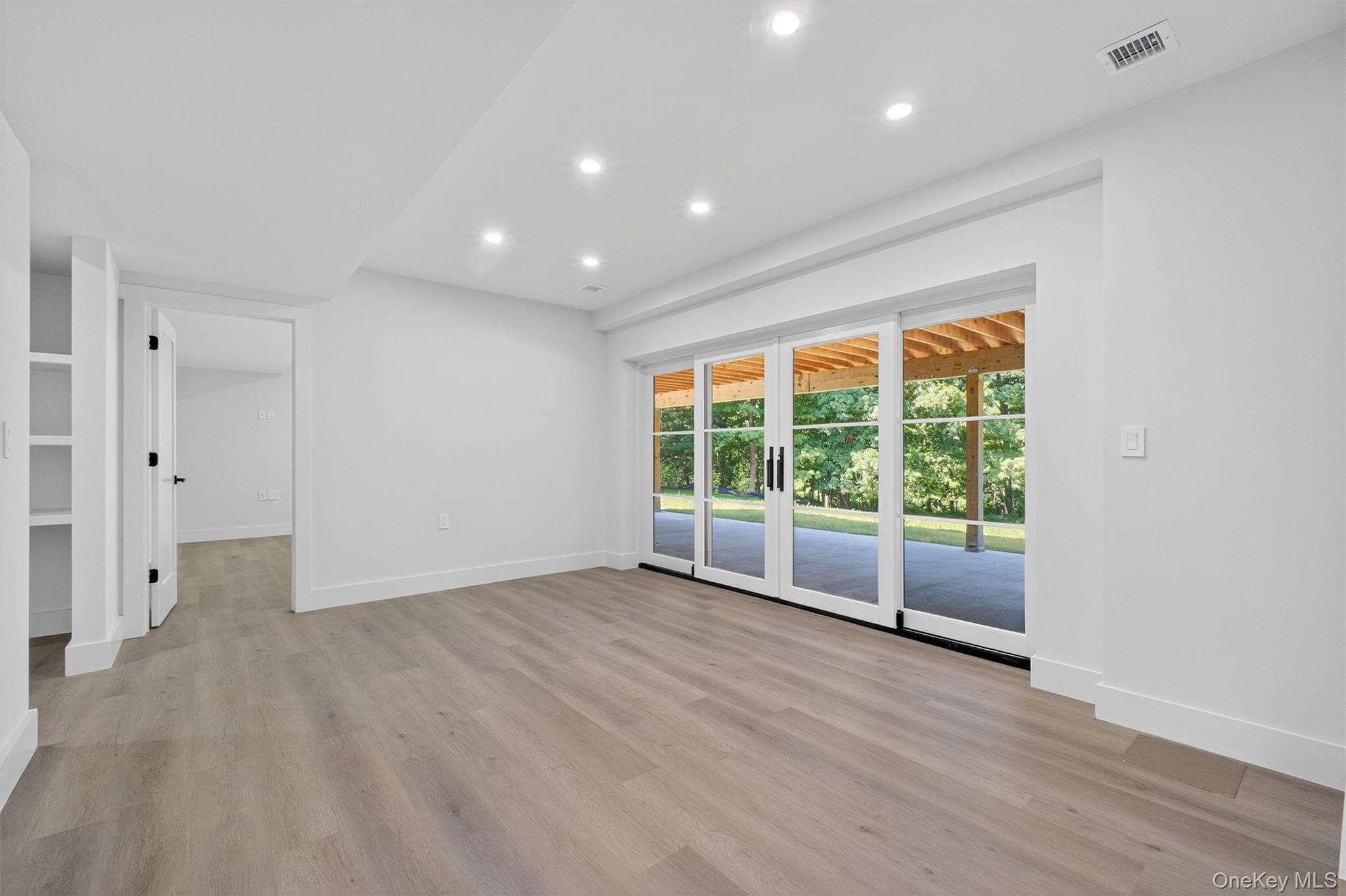 64 Stonehouse Road Somers, NY 10589 - Photo 35 of 48 a view of an empty room with wooden floor and a window
